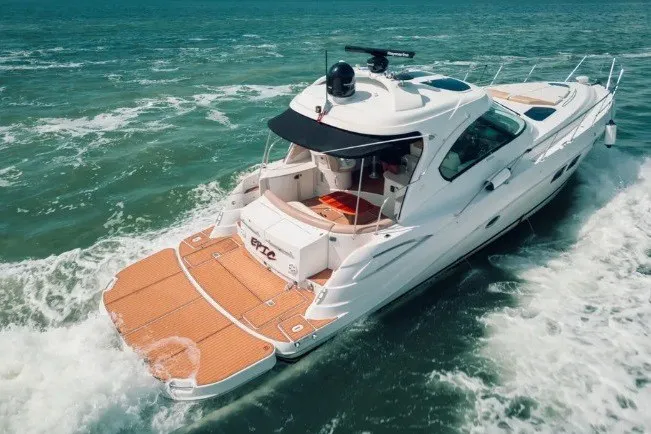 Slide: The Image of 2009 Four Winns V458 yacht cruising on open water, showcasing sleek design and spacious deck. - 5
