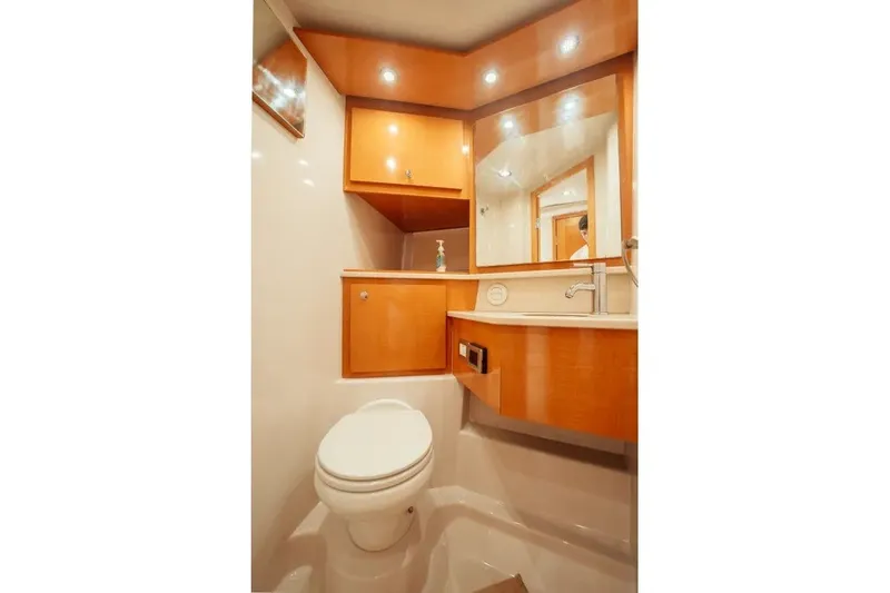 Slide: The Image of Luxurious 2009 Four Winns V458 yacht bathroom with modern fixtures and wooden cabinetry. - 14
