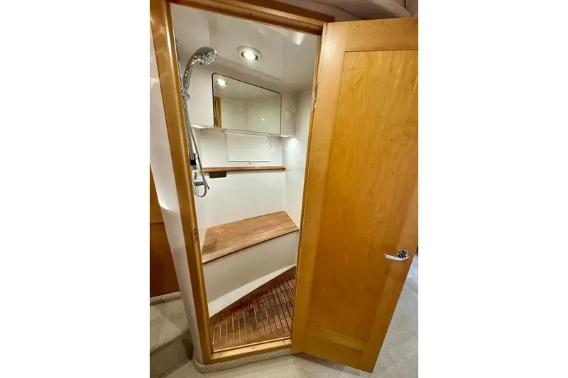 Slide: The Image of 2009 Four Winns V458 yacht shower with wooden accents and modern fixtures. - 15