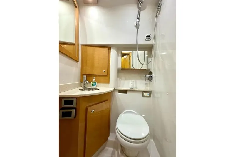 Slide: The Image of 2009 Four Winns V458 yacht bathroom with modern fixtures, wooden cabinetry, and compact design. - 16