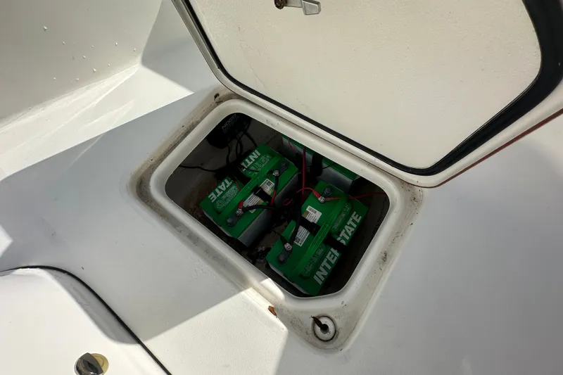 Slide: The Image of Open hatch revealing batteries in a 2018 Sea Pro 248 Bay boat. - 14