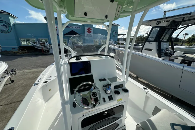 Slide: The Image of 2018 Sea Pro 248 Bay boat dashboard with steering wheel and navigation controls. - 6