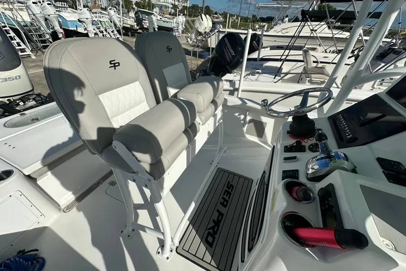 Slide: The Image of 2018 Sea Pro 248 Bay boat interior with dual seats and control panel. - 16