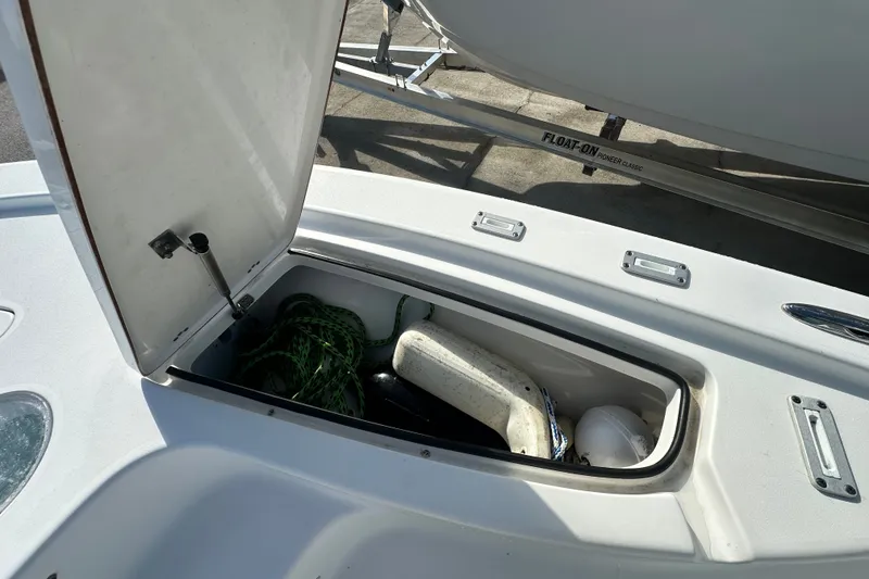 Slide: The Image of Open storage compartment on 2018 Sea Pro 248 Bay boat with ropes and fenders. - 12