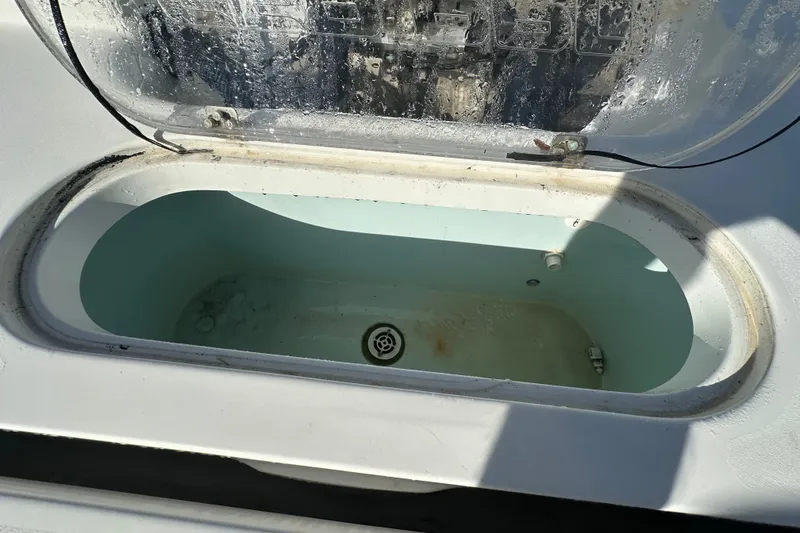 Slide: The Image of Open storage compartment on 2018 Sea Pro 248 Bay boat, showing interior details. - 20