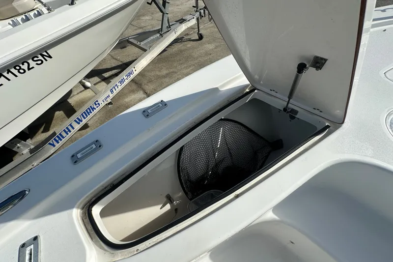 Slide: The Image of Open storage compartment on a 2018 Sea Pro 248 Bay boat, showing interior space. - 13