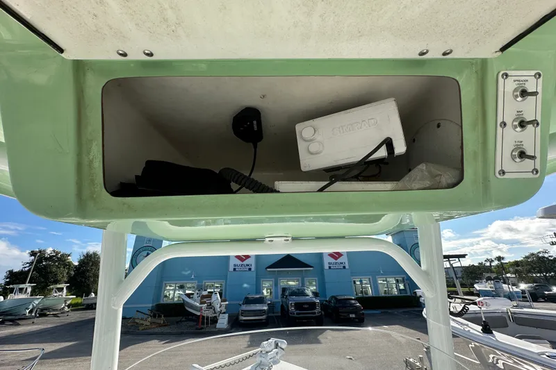 Slide: The Image of 2018 Sea Pro 248 Bay boat console storage with Simrad equipment and control switches. - 8