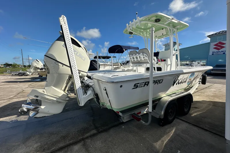 Slide: The Image of 2018 Sea Pro 248 Bay boat with Suzuki engine on trailer, parked outdoors. - 5
