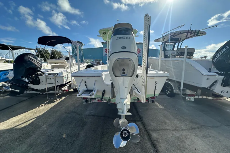 Slide: The Image of 2018 Sea Pro 248 Bay boat with powerful outboard motor, displayed in a sunny marina. - 4