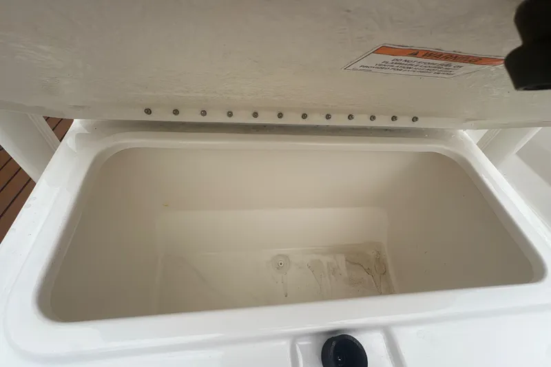 Slide: The Image of Open storage compartment on 2025 Bayliner Trophy T22CC boat, showcasing interior space. - 21