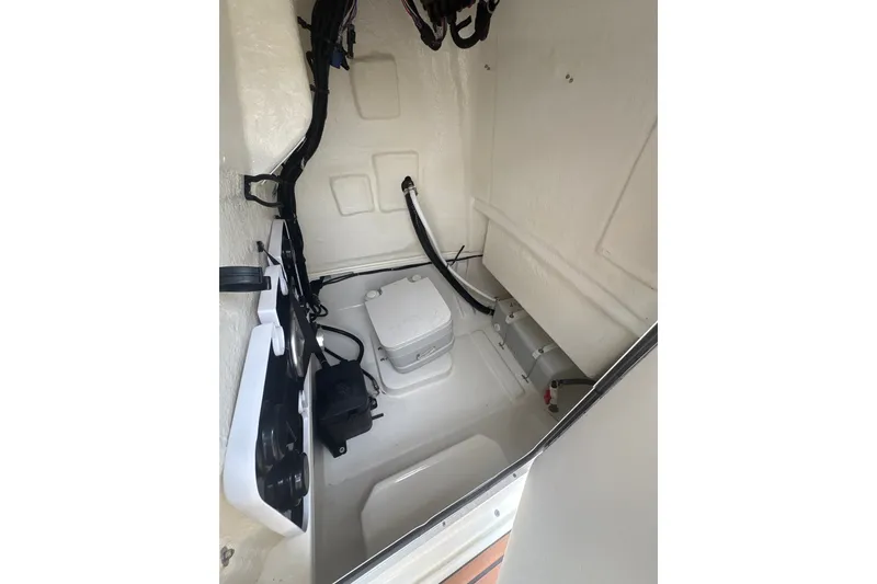 Slide: The Image of Interior of 2025 Bayliner Trophy T22CC boat, featuring storage and equipment space. - 8
