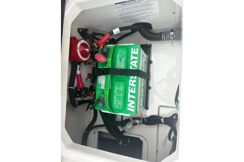Slide: The Image of Battery compartment of 2025 Bayliner Trophy T22CC with Interstate battery and wiring. - 24