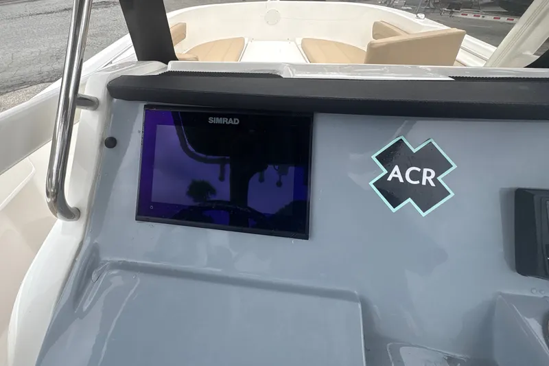 Slide: The Image of 2025 Bayliner Trophy T22CC dashboard with Simrad display and ACR sticker. - 11
