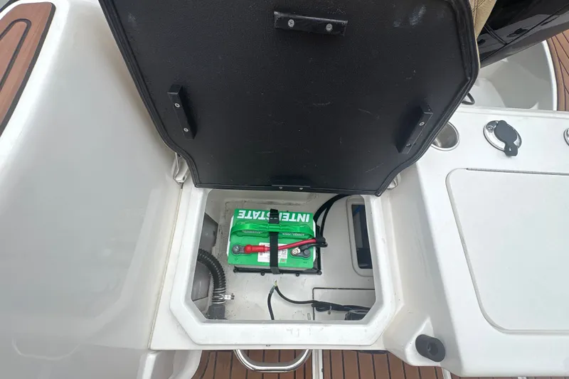 Slide: The Image of 2025 Bayliner Trophy T22CC boat battery compartment with Interstate battery visible. - 23