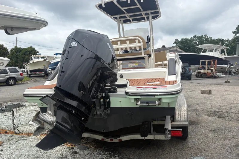Slide: The Image of 2025 Bayliner Trophy T22CC boat with powerful outboard motor, parked on a trailer. - 5