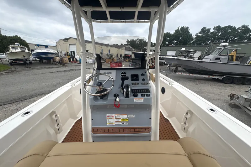 Slide: The Image of 2025 Bayliner Trophy T22CC boat interior with steering wheel and control panel. - 7