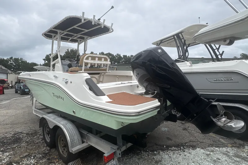 Slide: The Image of 2025 Bayliner Trophy T22CC boat on trailer, featuring sleek design and powerful outboard motor. - 4