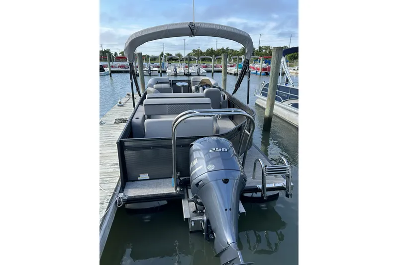 Slide: The Image of 2024 Qwest E822 Splash Pad pontoon boat docked with Yamaha 250 engine. - 2