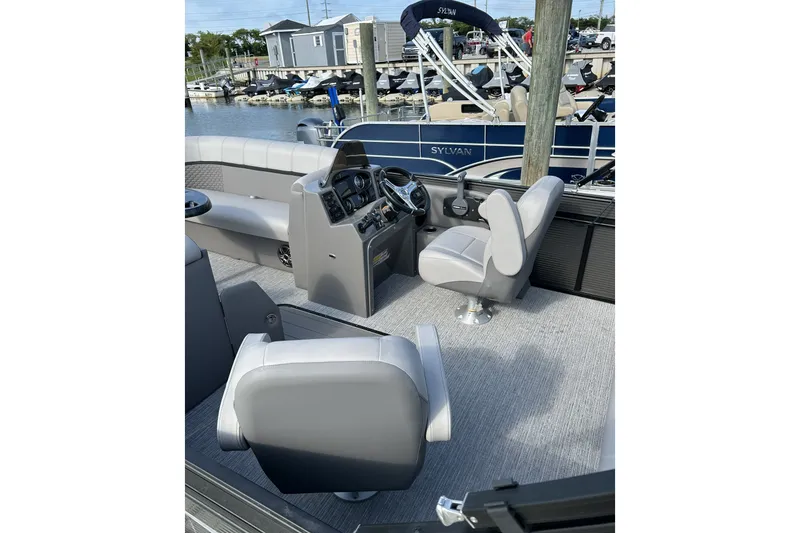 Slide: The Image of 2024 Qwest E822 Splash Pad boat interior with modern seating and control panel. - 5