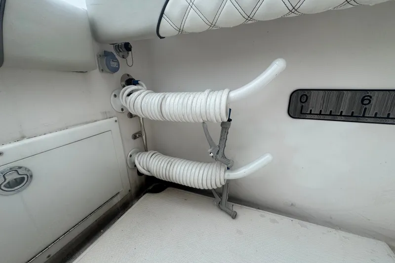 Slide: The Image of Interior of 2011 Donzi 29 ZF Open boat with coiled hoses and storage compartment. - 23