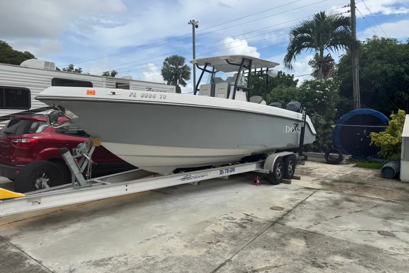 Slide: The Image of 2011 Donzi 29 ZF Open boat on trailer, parked outdoors. - 13