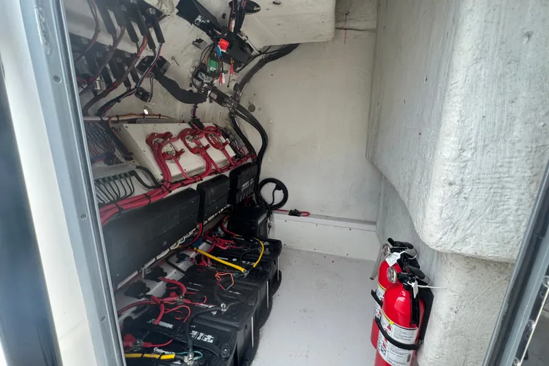 Slide: The Image of Electrical compartment of a 2011 Donzi 29 ZF Open boat with batteries and fire extinguishers. - 44