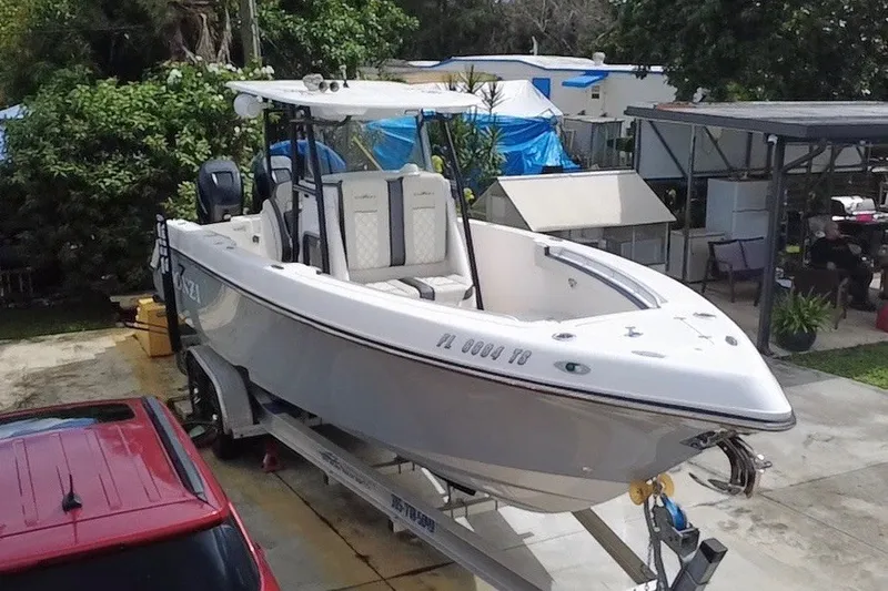 Slide: The Image of 2011 Donzi 29 ZF Open boat on trailer in residential driveway. - 2