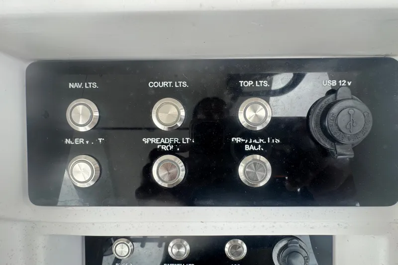 Slide: The Image of Control panel of a 2011 Donzi 29 ZF Open boat with labeled switches. - 35