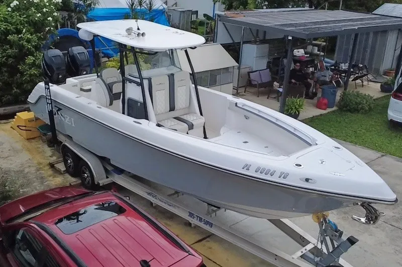 Slide: The Image of 2011 Donzi 29 ZF Open boat on trailer, parked in a residential driveway. - 7