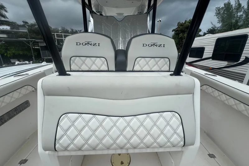 Slide: The Image of 2011 Donzi 29 ZF Open boat interior with white quilted seats and Donzi logo. - 42