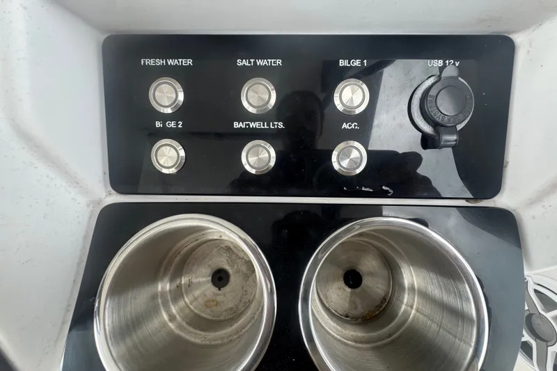 Slide: The Image of Control panel and cup holders on a 2011 Donzi 29 ZF Open boat. - 36