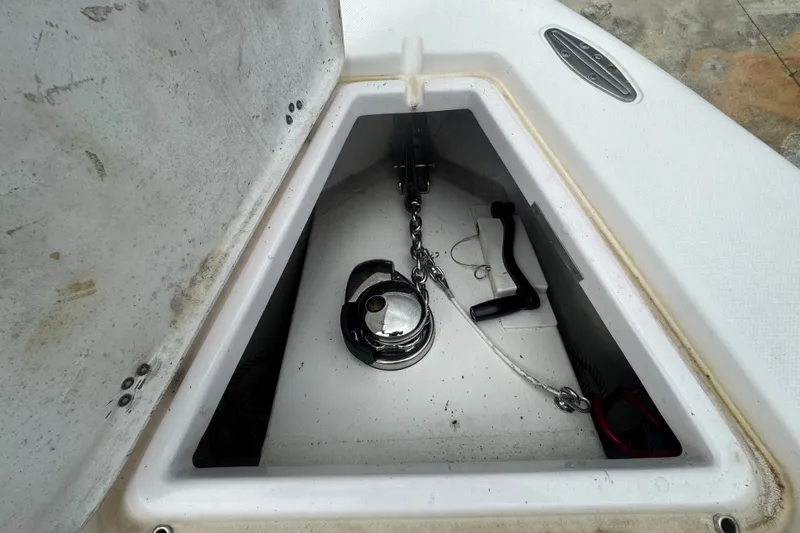 Slide: The Image of Anchor compartment of 2011 Donzi 29 ZF Open boat with chain and handle. - 51
