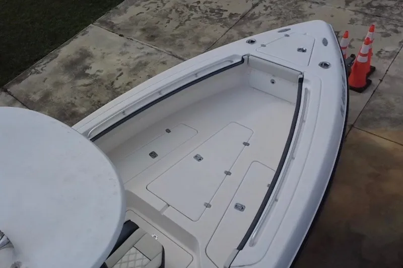 Slide: The Image of 2011 Donzi 29 ZF Open boat deck with storage compartments and safety cones nearby. - 15