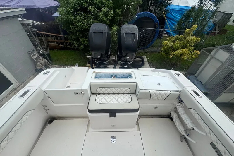 Slide: The Image of 2011 Donzi 29 ZF Open boat interior with dual engines and cushioned seating. - 17