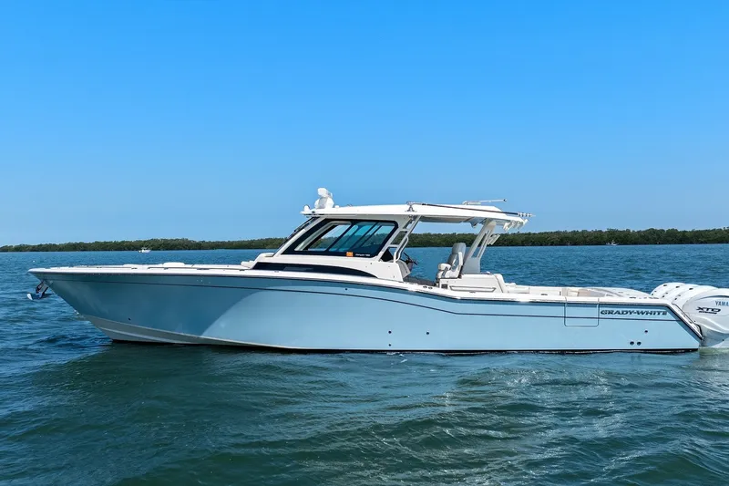 Slide: The Image of 2023 Grady-White Canyon 456 boat cruising on open water. - 4