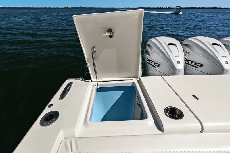 Slide: The Image of 2023 Grady-White Canyon 456 boat with open storage compartment and powerful outboard engines. - 33