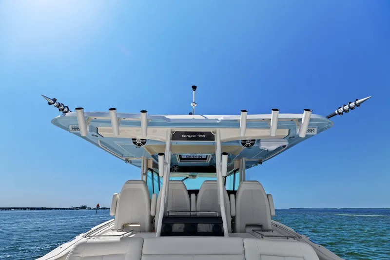 Slide: The Image of 2023 Grady-White Canyon 456 boat on open water under clear blue sky. - 37