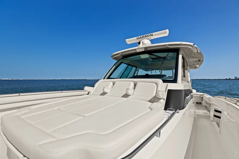 Slide: The Image of 2023 Grady-White Canyon 456 boat on open water, featuring luxurious seating and Garmin equipment. - 66