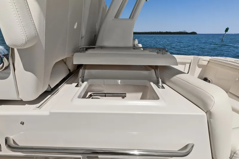 Slide: The Image of 2023 Grady-White Canyon 456 boat interior with open storage compartment, ocean view. - 38