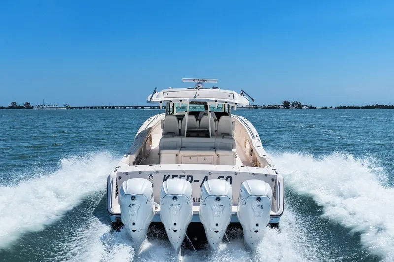 Slide: The Image of 2023 Grady-White Canyon 456 boat cruising on open water, showcasing powerful engines. - 20