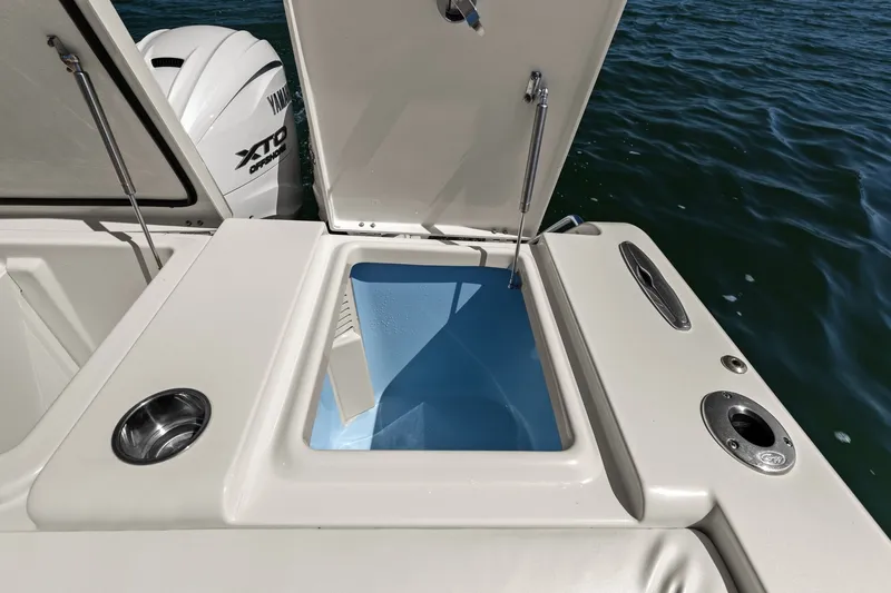 Slide: The Image of 2023 Grady-White Canyon 456 boat with open storage compartment and Yamaha XTO engine. - 35
