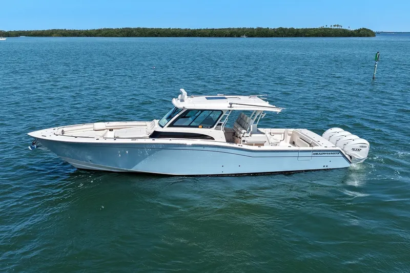 Slide: The Image of 2023 Grady-White Canyon 456 boat cruising on open water. - 7