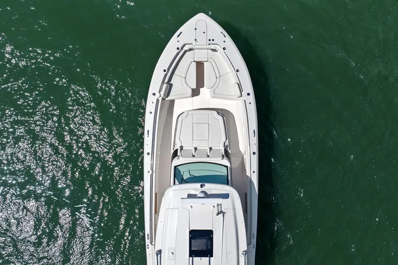 Slide: The Image of Aerial view of 2023 Grady-White Canyon 456 boat on green water. - 24
