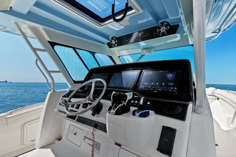 Slide: The Image of 2023 Grady-White Canyon 456 helm with advanced navigation displays and steering wheel. - 43