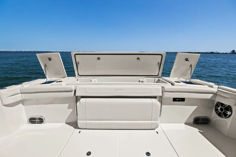 Slide: The Image of 2023 Grady-White Canyon 456 boat deck with open storage compartments, ocean view. - 32