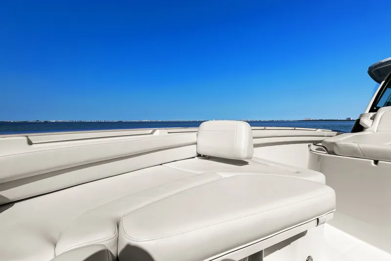 Slide: The Image of 2023 Grady-White Canyon 456 boat interior with luxurious seating, ocean view, and clear blue sky. - 62