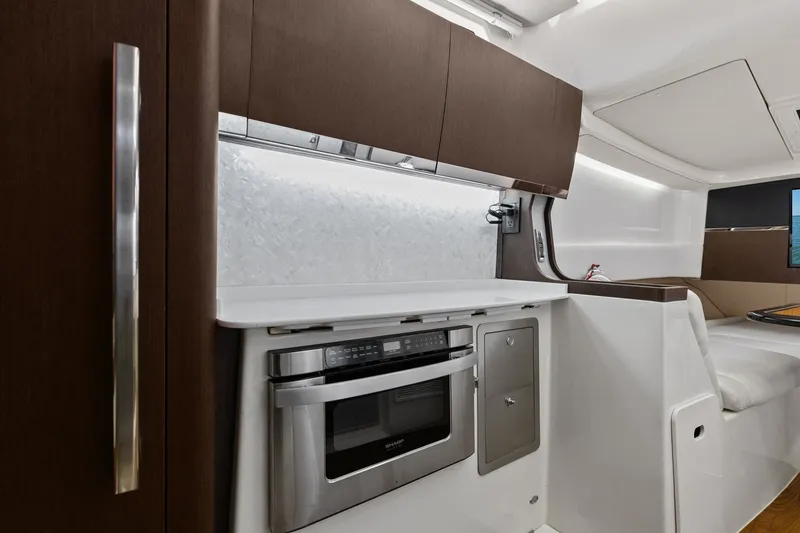 Slide: The Image of 2023 Grady-White Canyon 456 interior with modern kitchen and sleek cabinetry. - 52