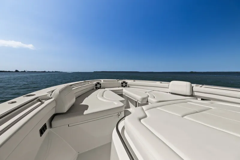 Slide: The Image of 2023 Grady-White Canyon 456 boat interior with luxurious seating on open water. - 60