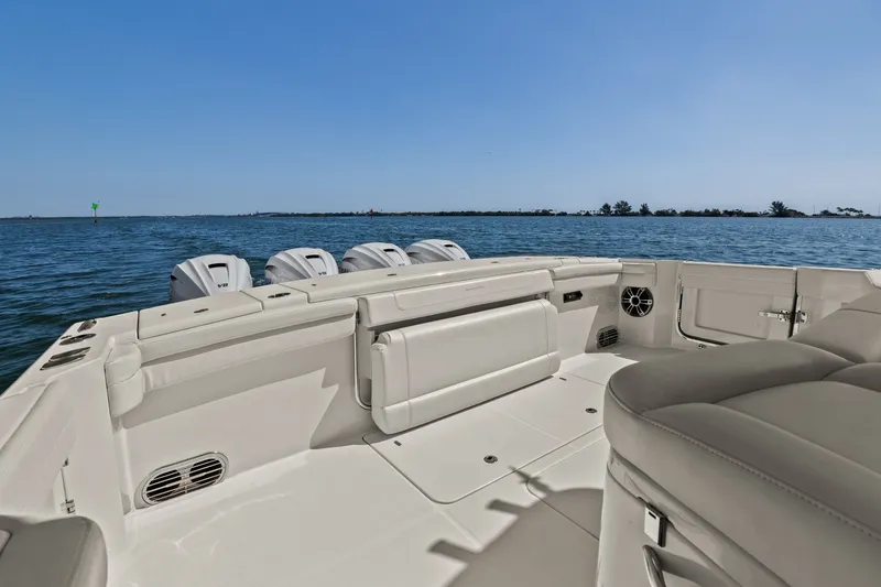 Slide: The Image of 2023 Grady-White Canyon 456 boat interior with ocean view, showcasing luxury seating and powerful engines. - 29