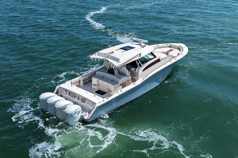 Slide: The Image of 2023 Grady-White Canyon 456 boat cruising on open water. - 23